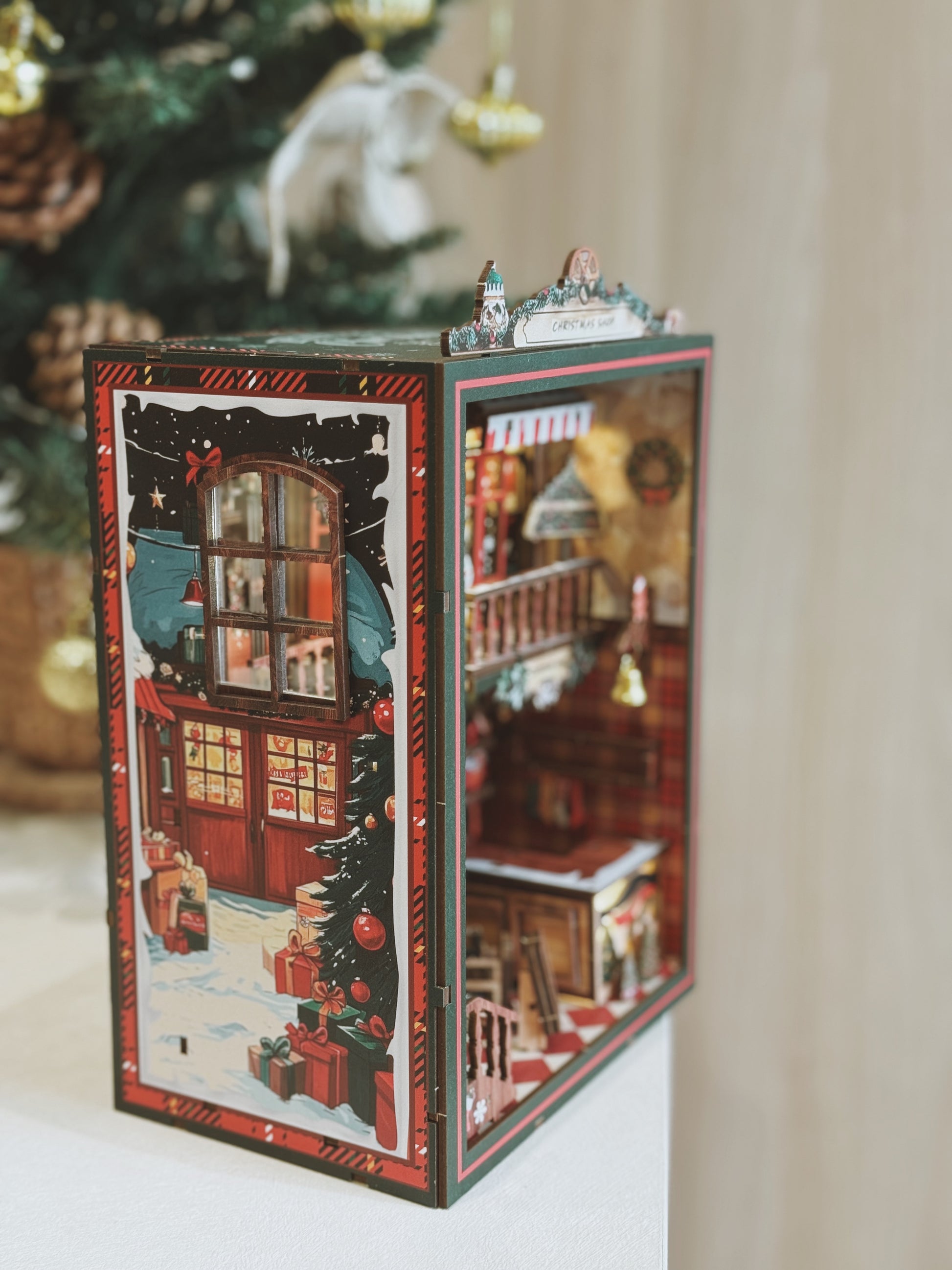 Decorative Christmas book nook with a miniature house design.