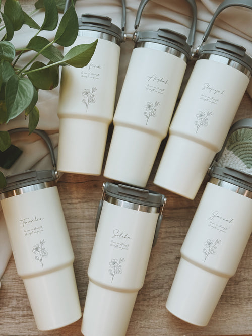 Flat lay of engraved tumblers and handwritten note, featuring stories behind intentional gifting from Tabletopics